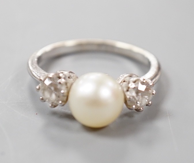 A white metal (stamped plat), single stone diamond and two stone cultured pearl set dress ring, size M, gross weight 4.2 grams.